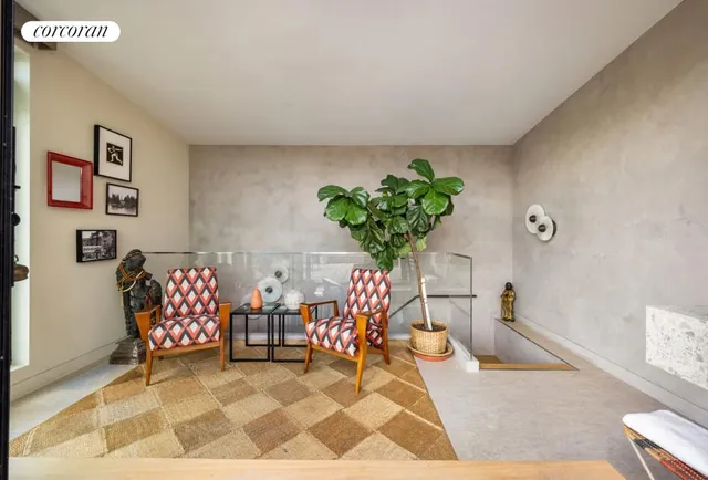 a living room with furniture and flowers