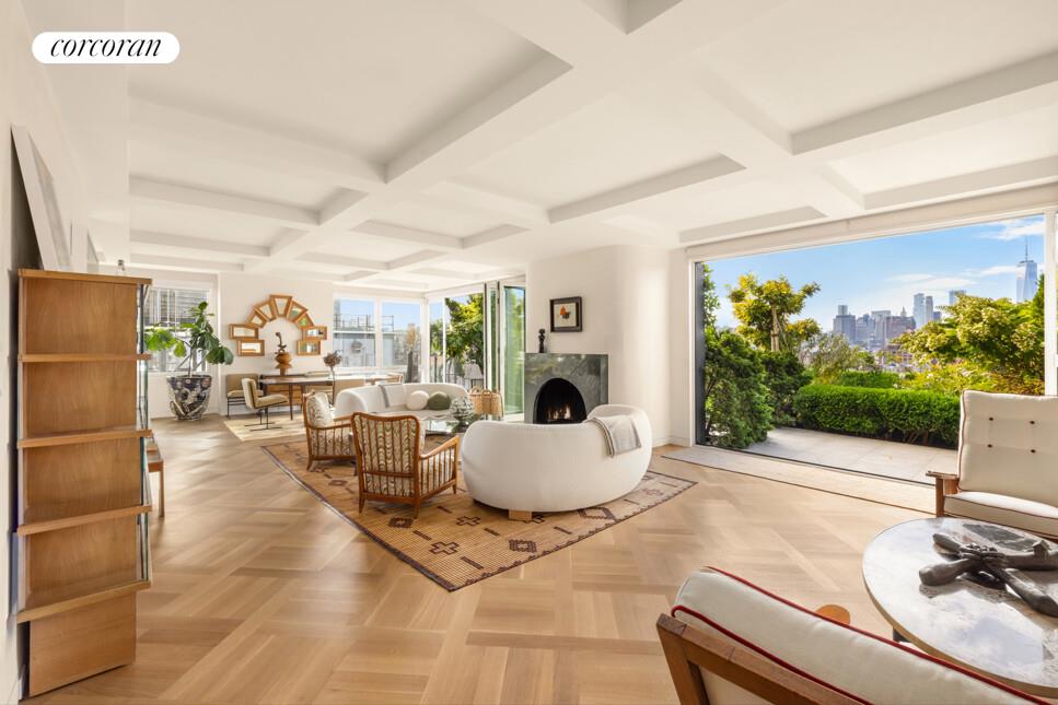 65 West 13th Street, Unit PHD Manhattan, NY 10011 - Photo 2 of 24 a living room with furniture a flat screen tv and a large window
