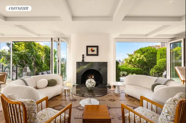 a living room with furniture a flat screen tv and a large window