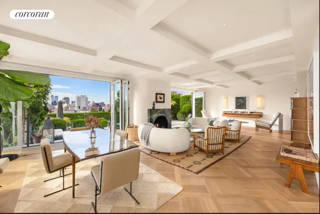 a living room with furniture a large window and a fireplace