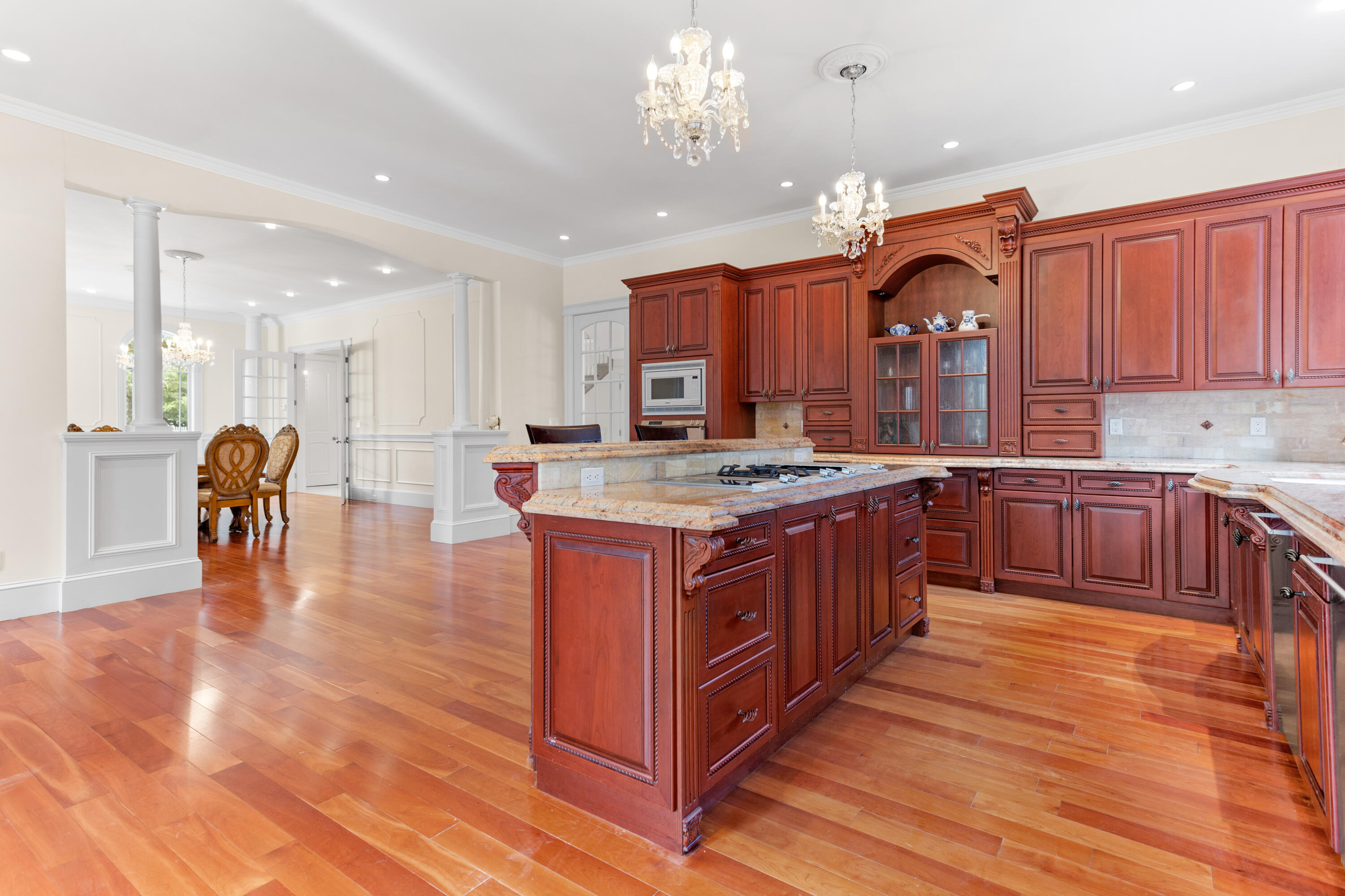 10 Starboard Lane Osterville, MA 02655 - Photo 2 of 22 a kitchen with stainless steel appliances granite countertop a stove a sink dishwasher a refrigerator and a dining table with wooden floor