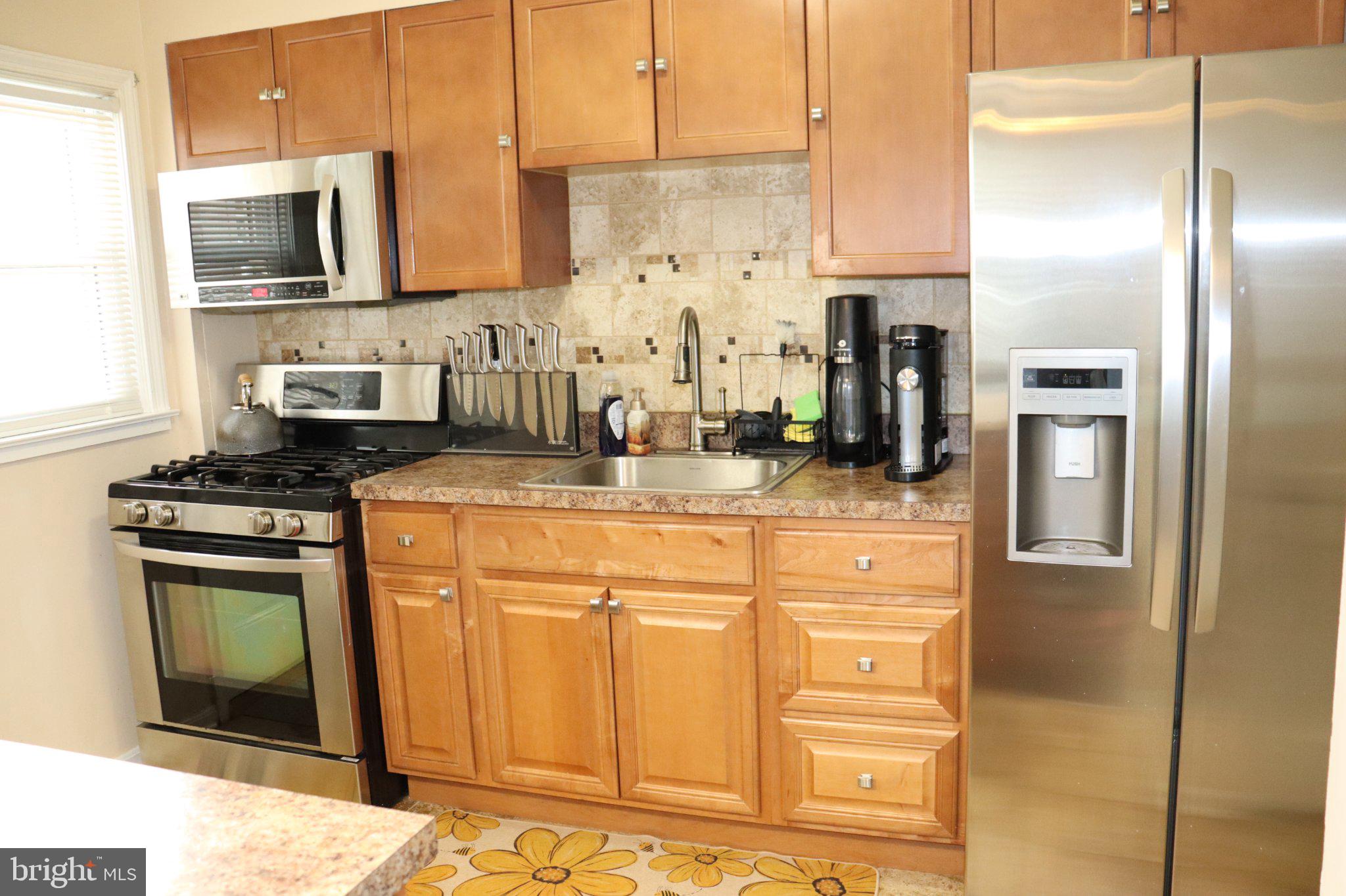 1328 Cedarcroft Road Baltimore, MD 21239 - Photo 7 of 39 Modern kitchen with warm wood tones.