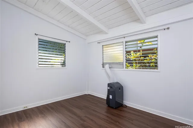 a view of a room with wooden floor and a window