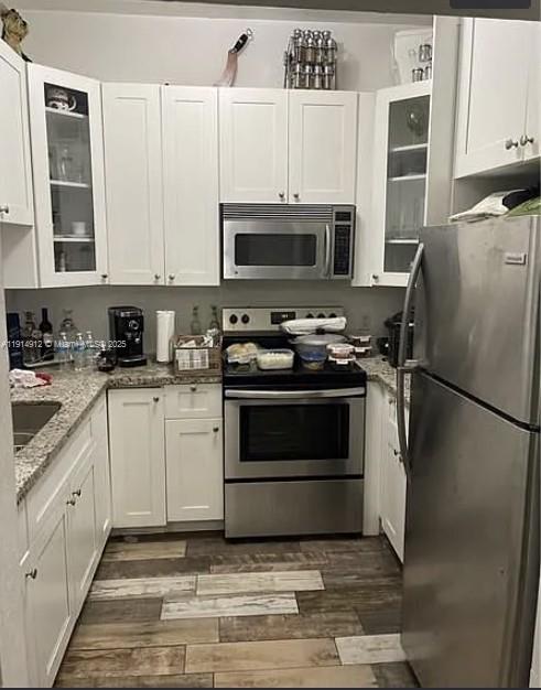 2125 Northwest 126th Street Miami, FL 33167 - Photo 3 of 6 a kitchen with cabinets stainless steel appliances and a counter space
