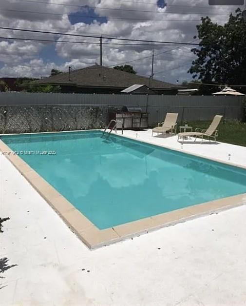 2125 Northwest 126th Street Miami, FL 33167 - Photo 4 of 6 a view of a swimming pool with a yard