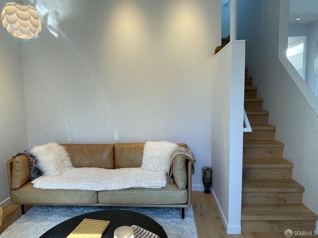 a living room with furniture potted plant and a fireplace