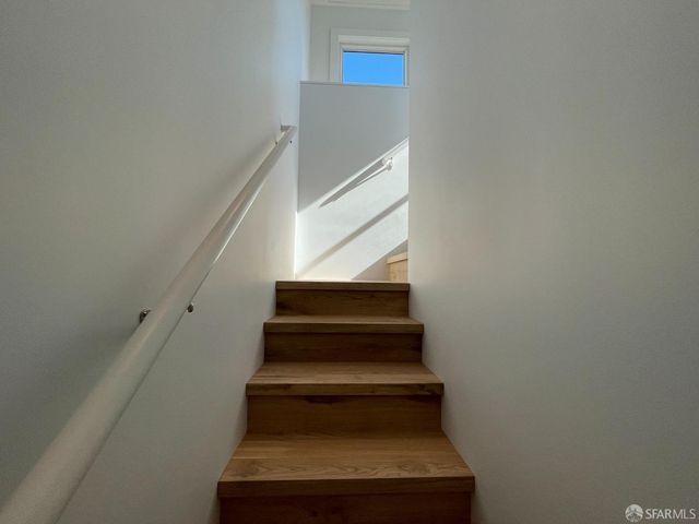 a view of a hallway with wooden shelves