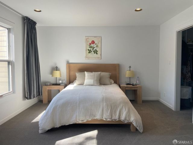 a room with a chair and a dresser in it