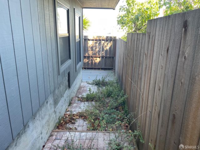 a backyard of a house with barbeque oven table and chairs