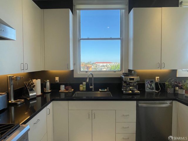 a kitchen with a sink and cabinets