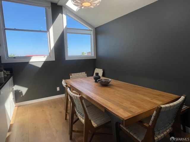 a dining room with a table chairs and wooden floor