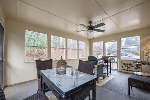 a view of a dining room with furniture large windows and wooden floor