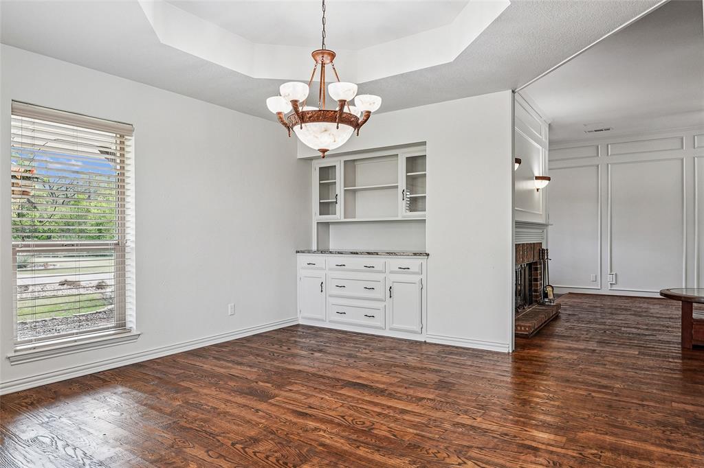 1006 Cochran Road Argyle, TX 76226 - Photo 10 of 40 a view of a kitchen with wooden floor and a ceiling fan