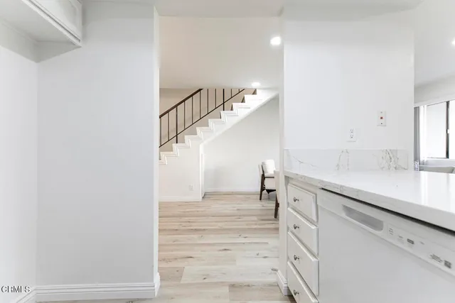 a view of entryway and hall with wooden floor