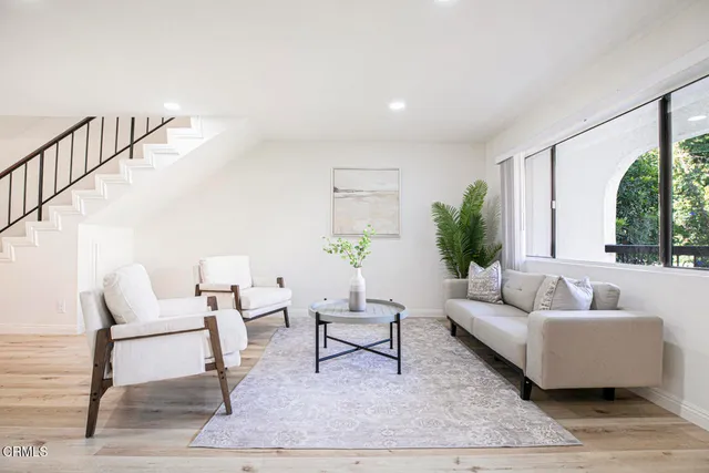 a living room with furniture and a potted plant
