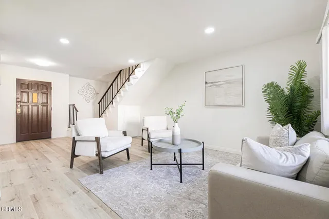 a living room with furniture and a potted plant