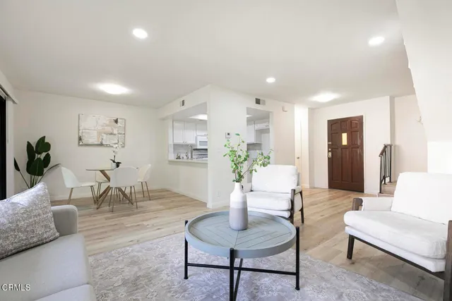 a living room with furniture potted plant and a table
