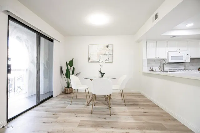 a view of a dining room with furniture window and outside view