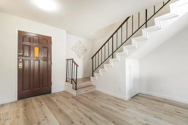 a view of entryway and hall with wooden floor
