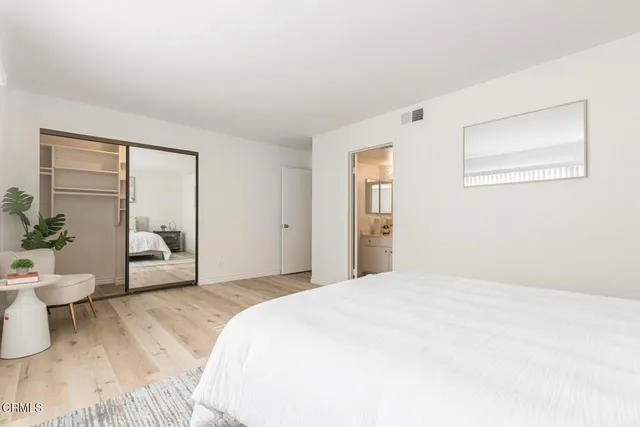 a bedroom with a large bed and a window