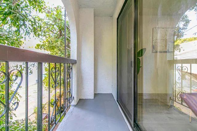 a view of balcony with wooden floor and fence