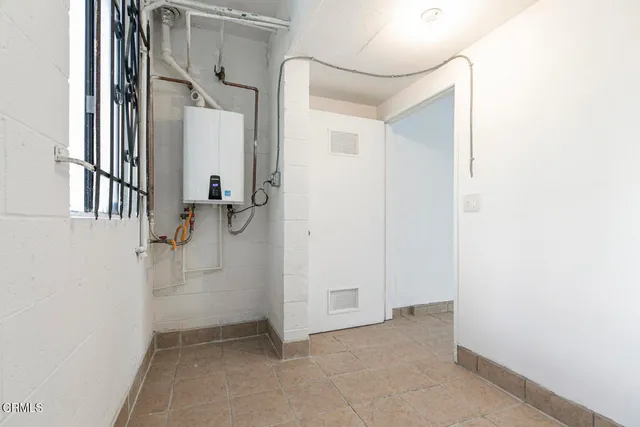 a view of house with car parked next to a road