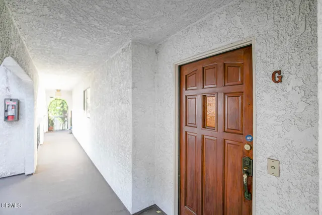 a view of a hallway with wooden floor and entryway