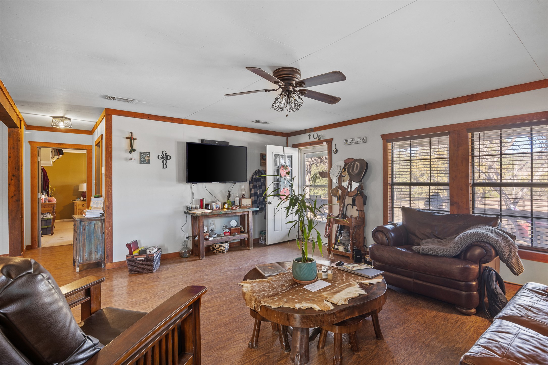 641 Patterson Creek Road Leakey, TX 78873 - Photo 21 of 31 Living area with a ceiling fan, wood finished floors, and ornamental molding