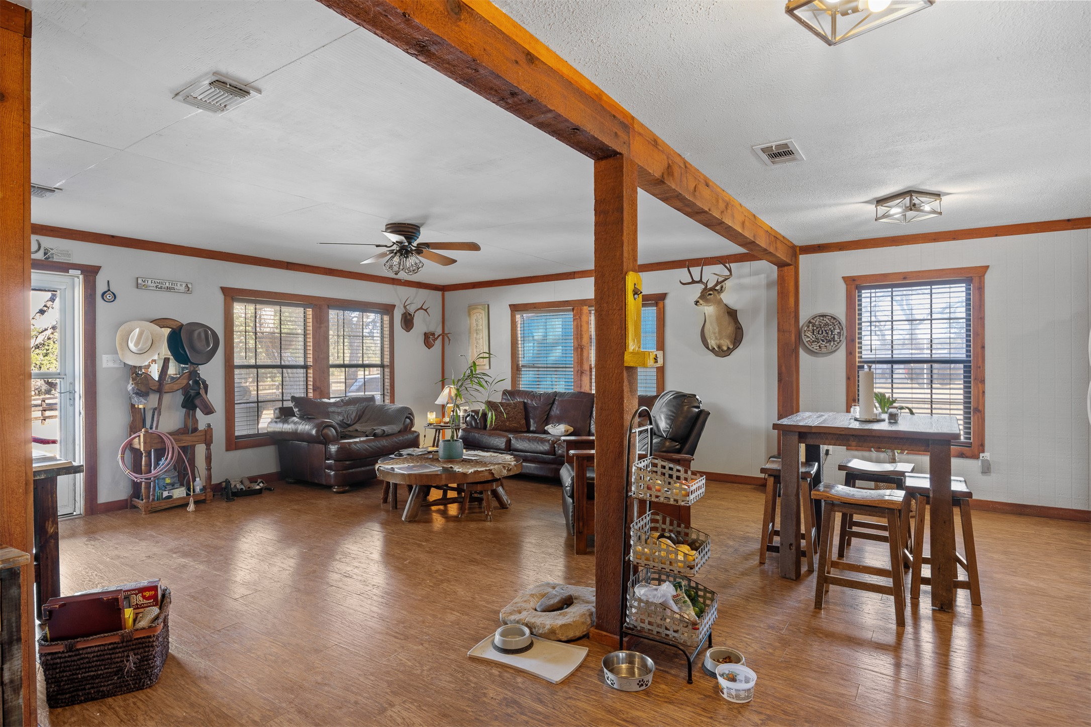 641 Patterson Creek Road Leakey, TX 78873 - Photo 22 of 31 Living room featuring ornamental molding, a ceiling fan, and wood finished floors