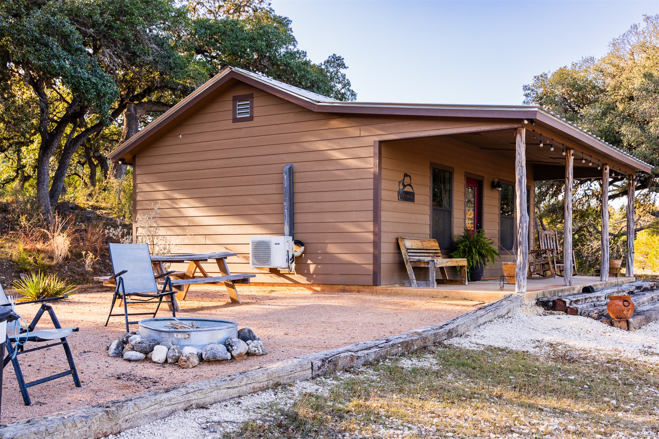 641 Patterson Creek Road Leakey, TX 78873 - Photo 23 of 31 Back of property with a fire pit and covered porch