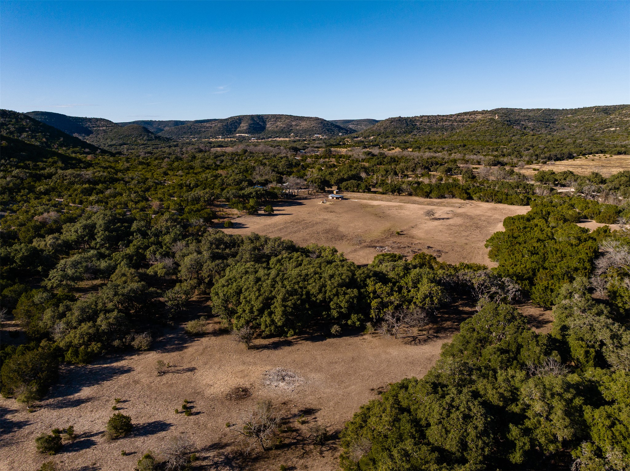 641 Patterson Creek Road Leakey, TX 78873 - Photo 10 of 31 Aerial view of property and surrounding area with a mountain backdrop