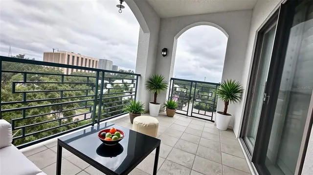 a view of a chairs and table in a balcony