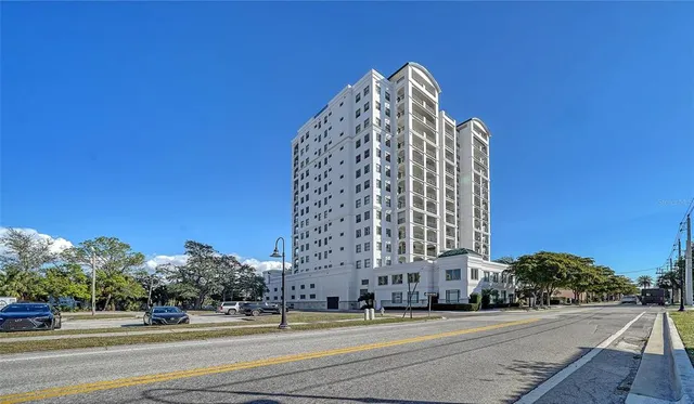 a view of a tall building next to a road