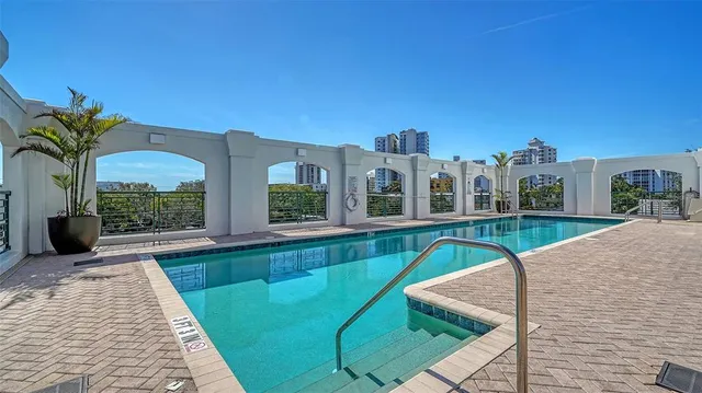 a view of a house with backyard patio and swimming pool