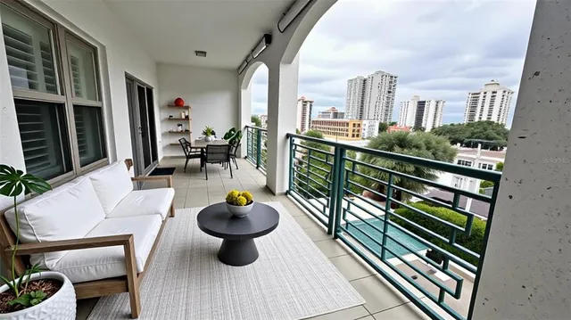a view of a patio with chairs and potted plants on the wall