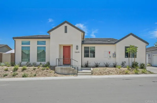 a front view of a house with lots of windows