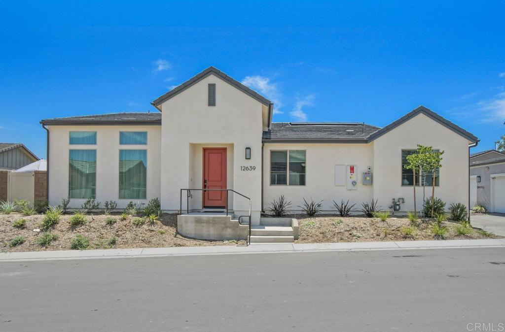 a front view of a house with lots of windows