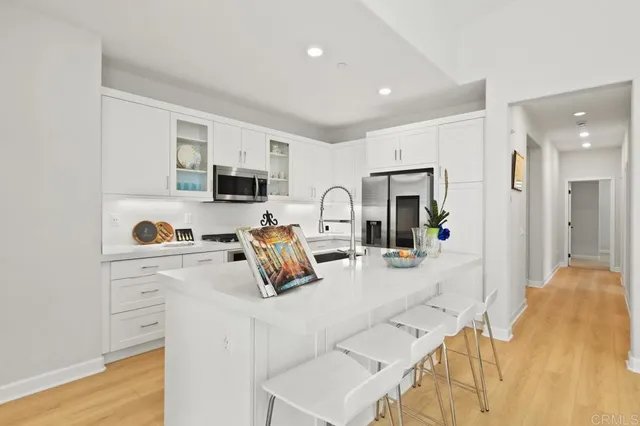 a kitchen with a sink stove and refrigerator