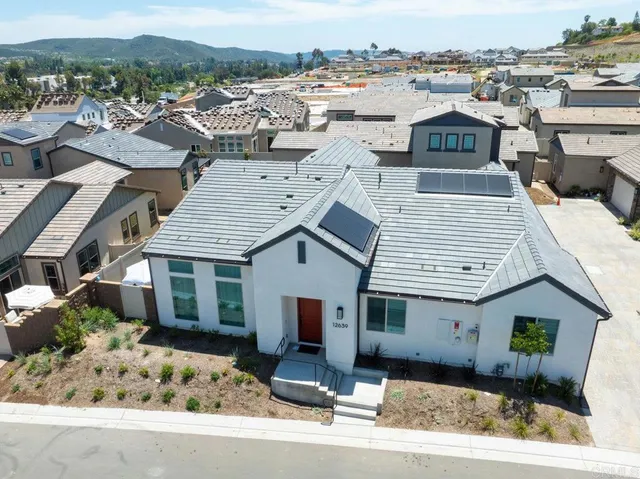 an aerial view of a house with a yard