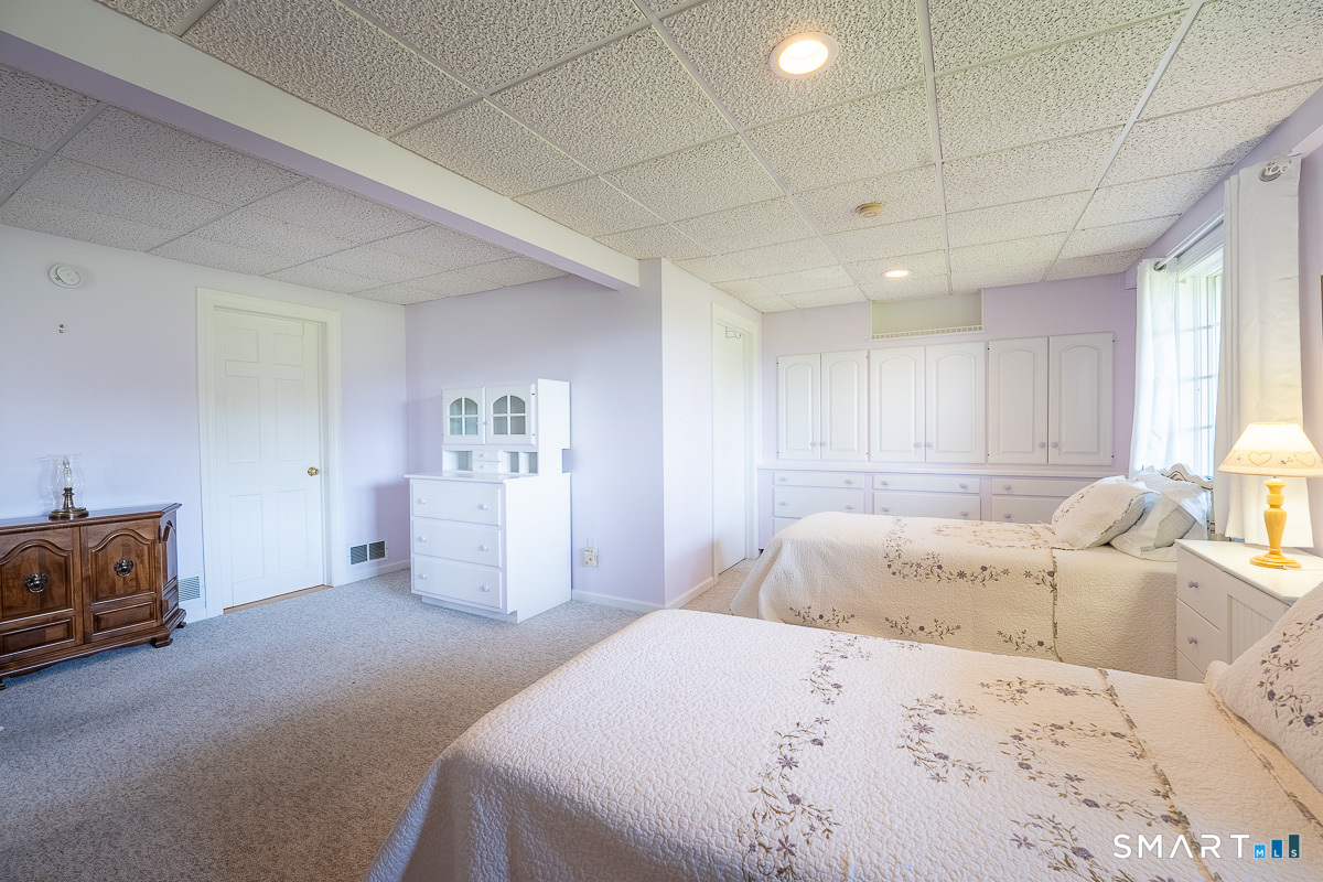 132 Latimer Point Road, Unit 132 Stonington, CT 06378 - Photo 23 of 38 Lower bedroom with existing twin beds and abundant closets.