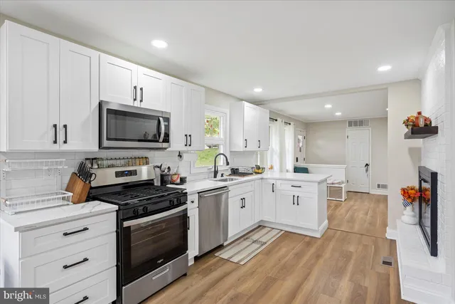 a kitchen with appliances a sink and cabinets