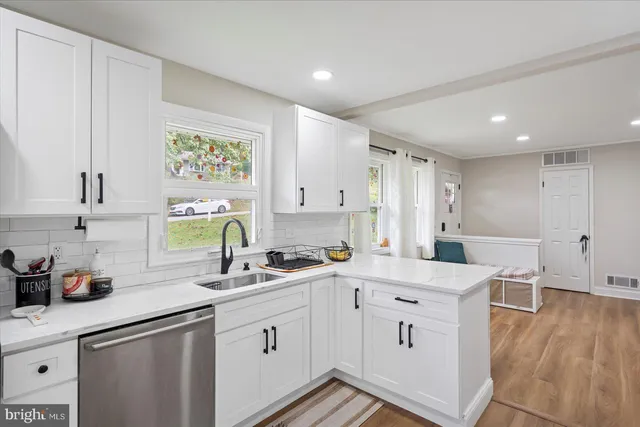 a kitchen with a sink window and cabinets