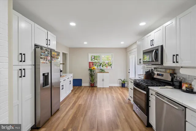 a kitchen with stainless steel appliances a refrigerator stove microwave and cabinets