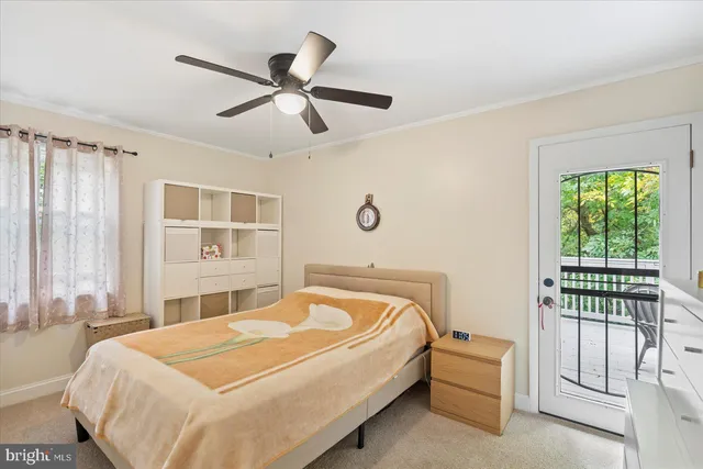 a bedroom with a bed and a chandelier fan