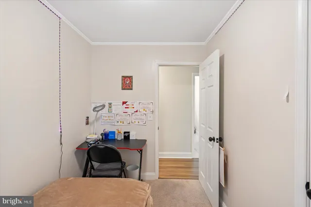 a view of a livingroom with workspace and a window