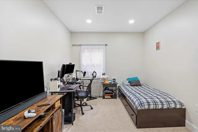 a bed room with a bed and a flat screen tv