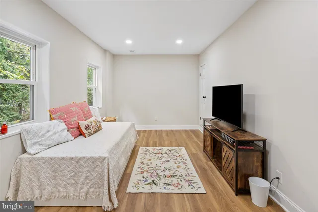 a bedroom with bed and a flat screen tv