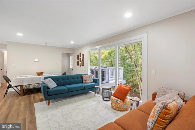 a living room with furniture and floor to ceiling window