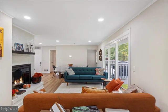 a living room with furniture fireplace and a window