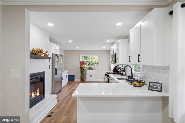 a kitchen with a refrigerator sink and cabinets